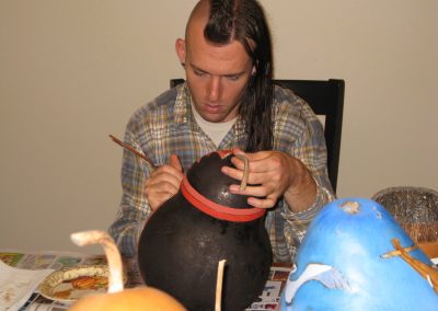 Ethan Brown painting the gourd