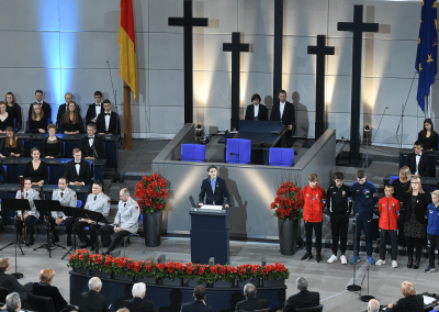 Football Remembers WW1’s young footballers present in the German parliament with special guests Angela Merkel and Emmanuel Macron in November 2018 to mark the centenary of the Armistice in a televised event.